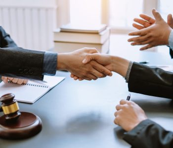 Man lawyer shaking hands with his clients in the office. Man lawyer shaking hands with his clients in the office.