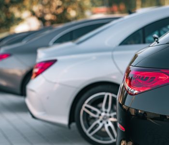 Selective focus view of different Mercedes-Benz cars parked in a row A selective focus view of different Mercedes-Benz cars parked in a row